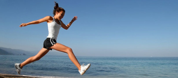 women sprinting on beach