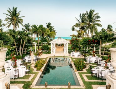 Turn celebrity wedding inspirations into reality at this sparkling pool surrounded by lush foliage and palm trees