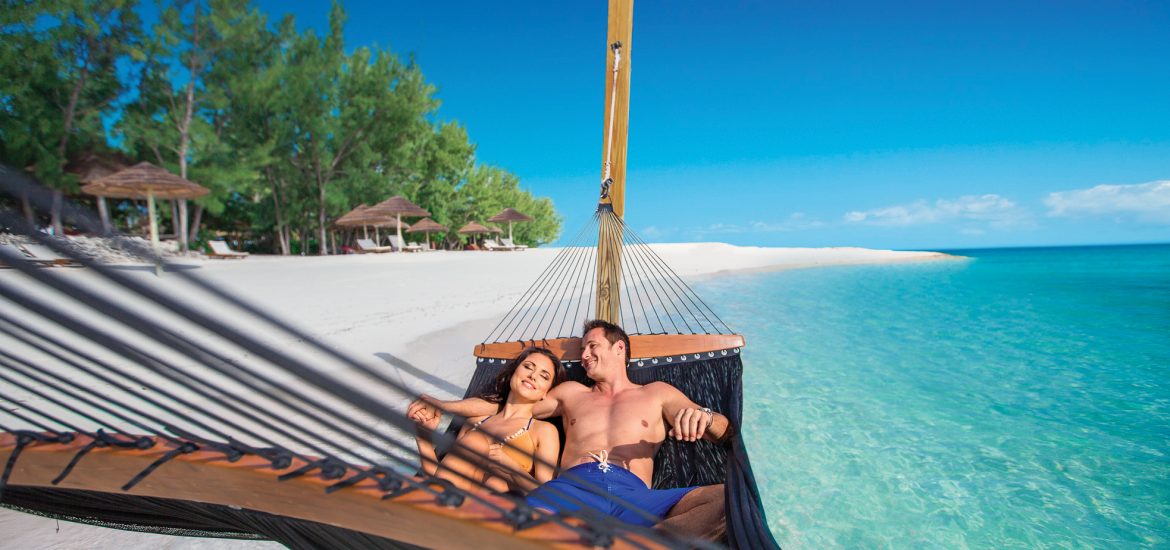 Couple on a hammock, choosing The Bahamas for their honeymoon destination