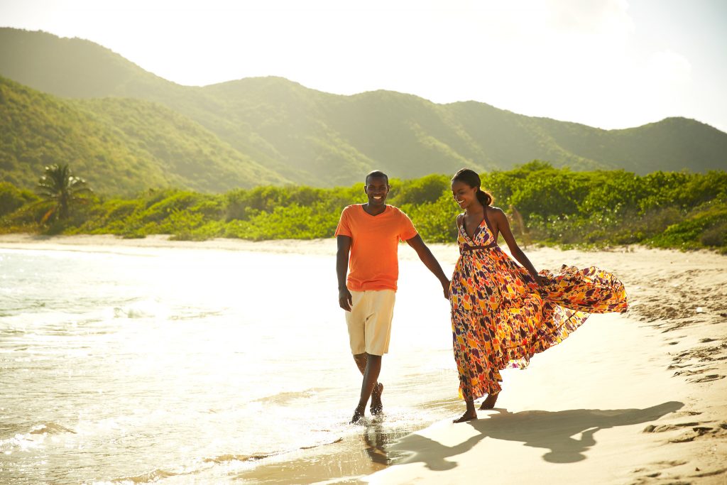 Couple strolls along the beach